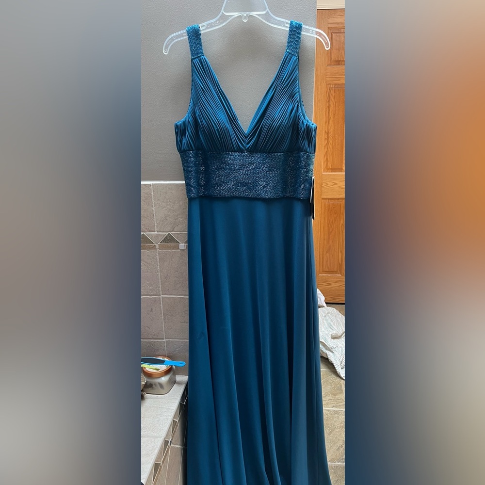 NWT deep turquoise blue formal beaded dress. Back zipper closure with hook.